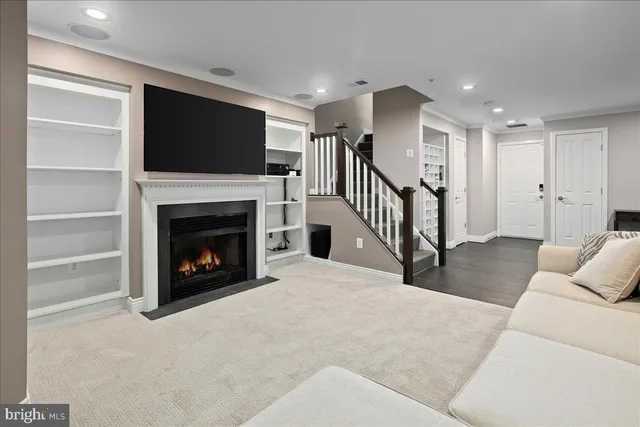 a living room with a fireplace and a flat screen tv