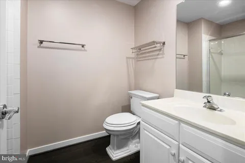 a bathroom with a sink a toilet and a mirror