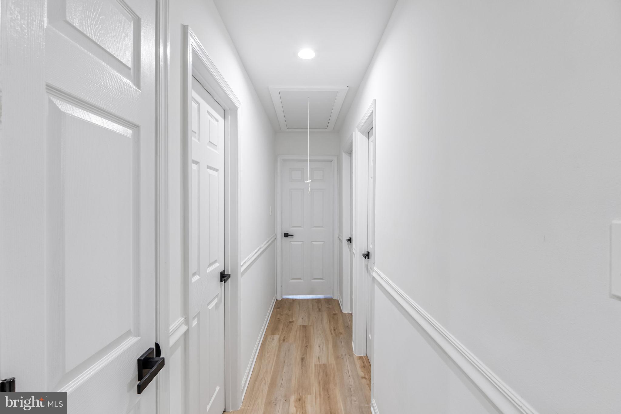 3 Boston Cove Ruther Glen, VA 22546 - Photo 18 of 30 a view of a hallway with wooden floor and staircase