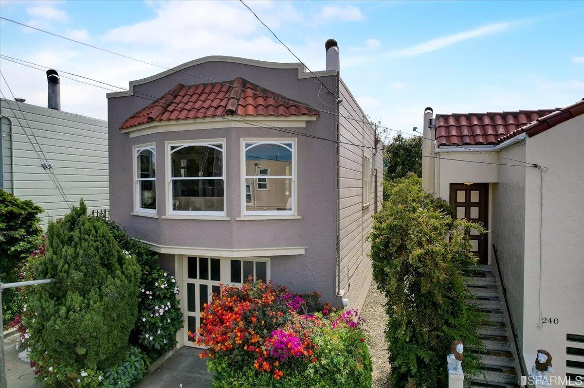 a front view of a house with plants