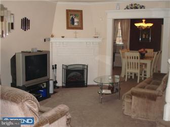 240 Wembly Road Upper Darby, PA 19082 - Photo 3 of 12 a living room with furniture a flat screen tv and a fireplace