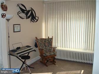 240 Wembly Road Upper Darby, PA 19082 - Photo 5 of 12 a bedroom with a chair and a window