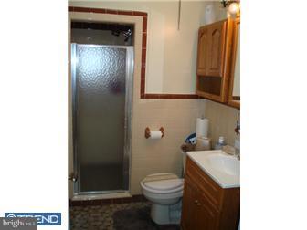 240 Wembly Road Upper Darby, PA 19082 - Photo 6 of 12 a bathroom with a granite countertop sink and a toilet