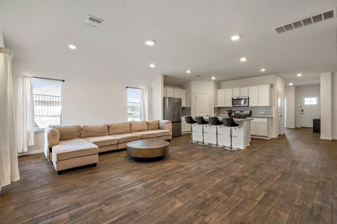 a living room with furniture and kitchen view