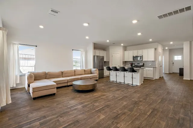 a living room with furniture and kitchen view