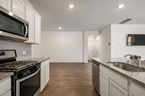 a kitchen that has a sink and a stove