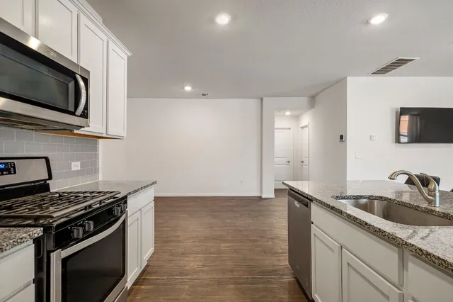 a kitchen that has a sink and a stove
