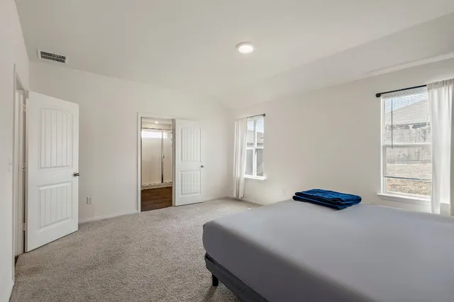 a bedroom with a bed and a window