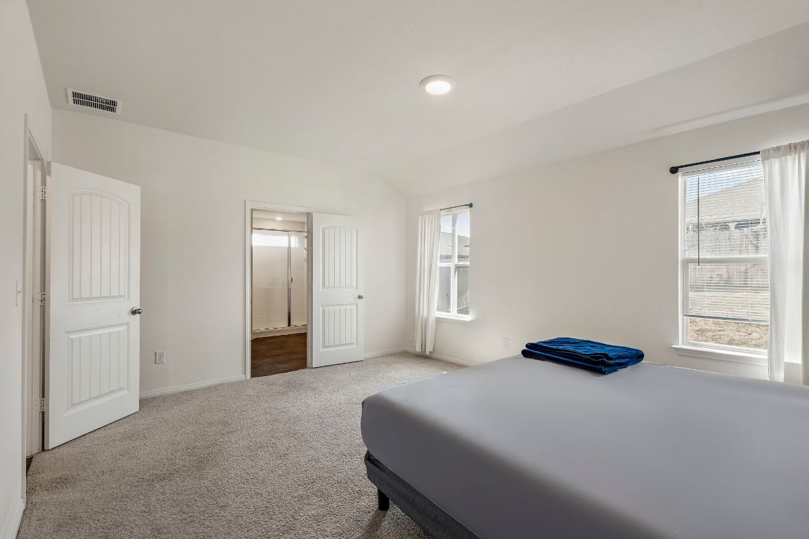 19601 Abigail Fillmore Road Manor, TX 78653 - Photo 9 of 17 a bedroom with a bed and a window