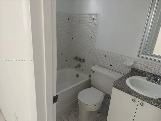 a bath room with a toilet and a bath tub