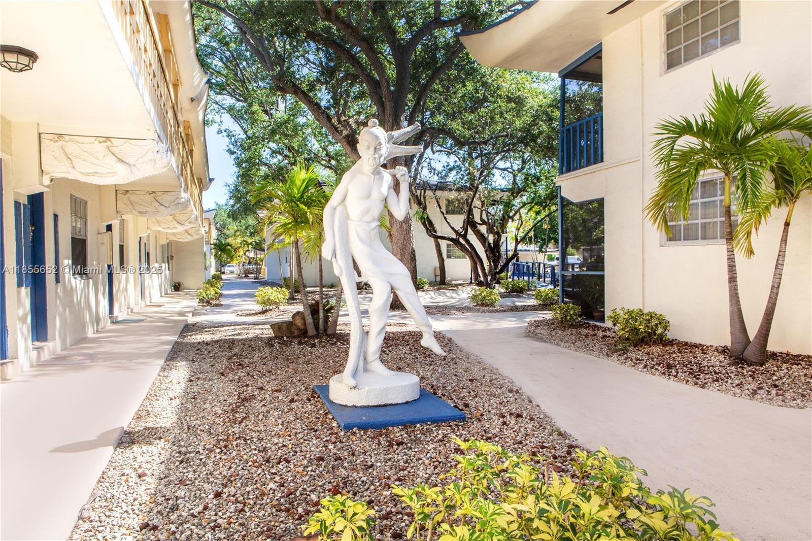 8350 Southwest 65th Avenue, Unit N4 Miami, FL 33143 - Photo 2 of 12 a view of a yard in front of a house
