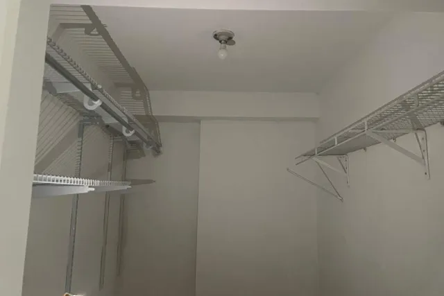 an empty room with closet area