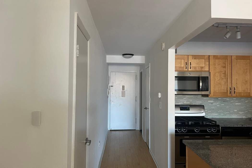 222 West 14th Street, Unit 6H Manhattan, NY 10011 - Photo 13 of 14 a kitchen with a refrigerator and a stove top oven