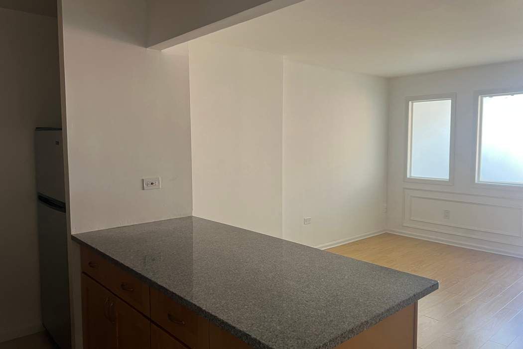 222 West 14th Street, Unit 6H Manhattan, NY 10011 - Photo 2 of 14 an empty room with windows