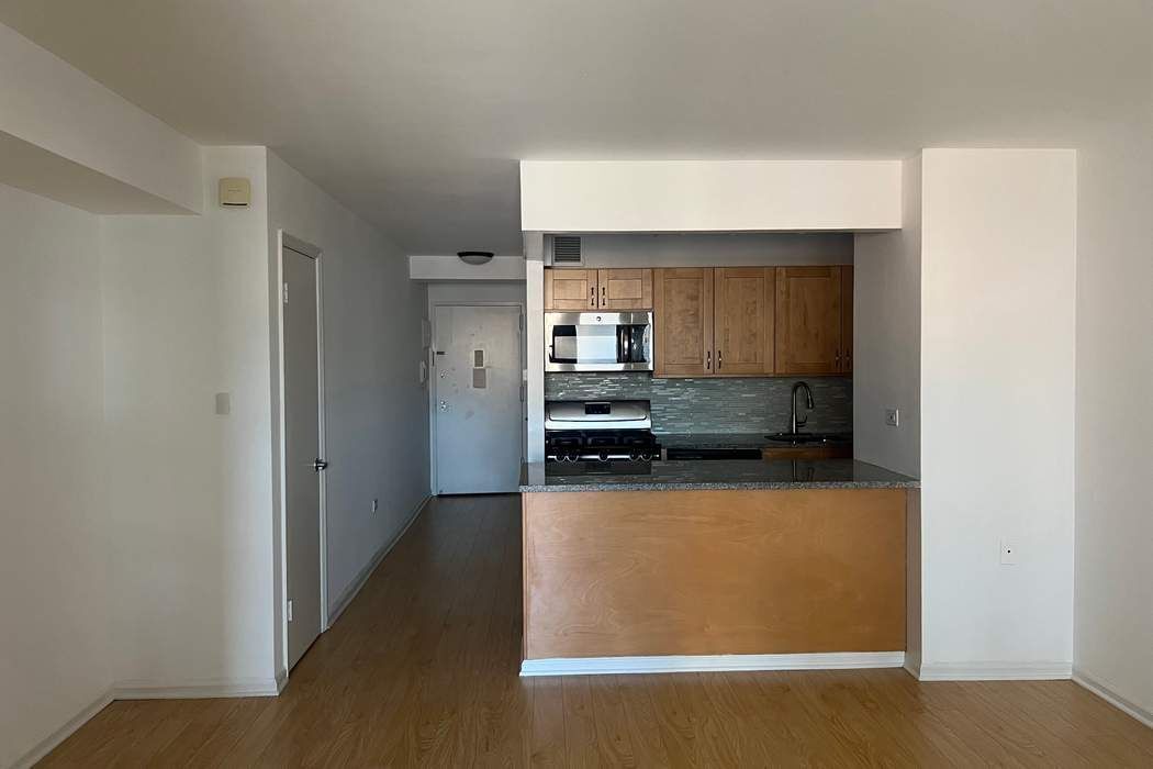 222 West 14th Street, Unit 6H Manhattan, NY 10011 - Photo 4 of 14 a kitchen with stainless steel appliances a refrigerator and a stove