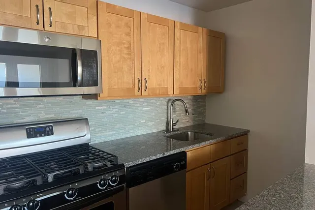 a kitchen with stainless steel appliances a refrigerator and a stove