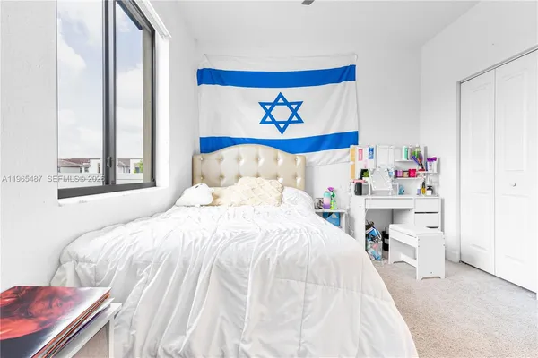 a bedroom with a bed and a window