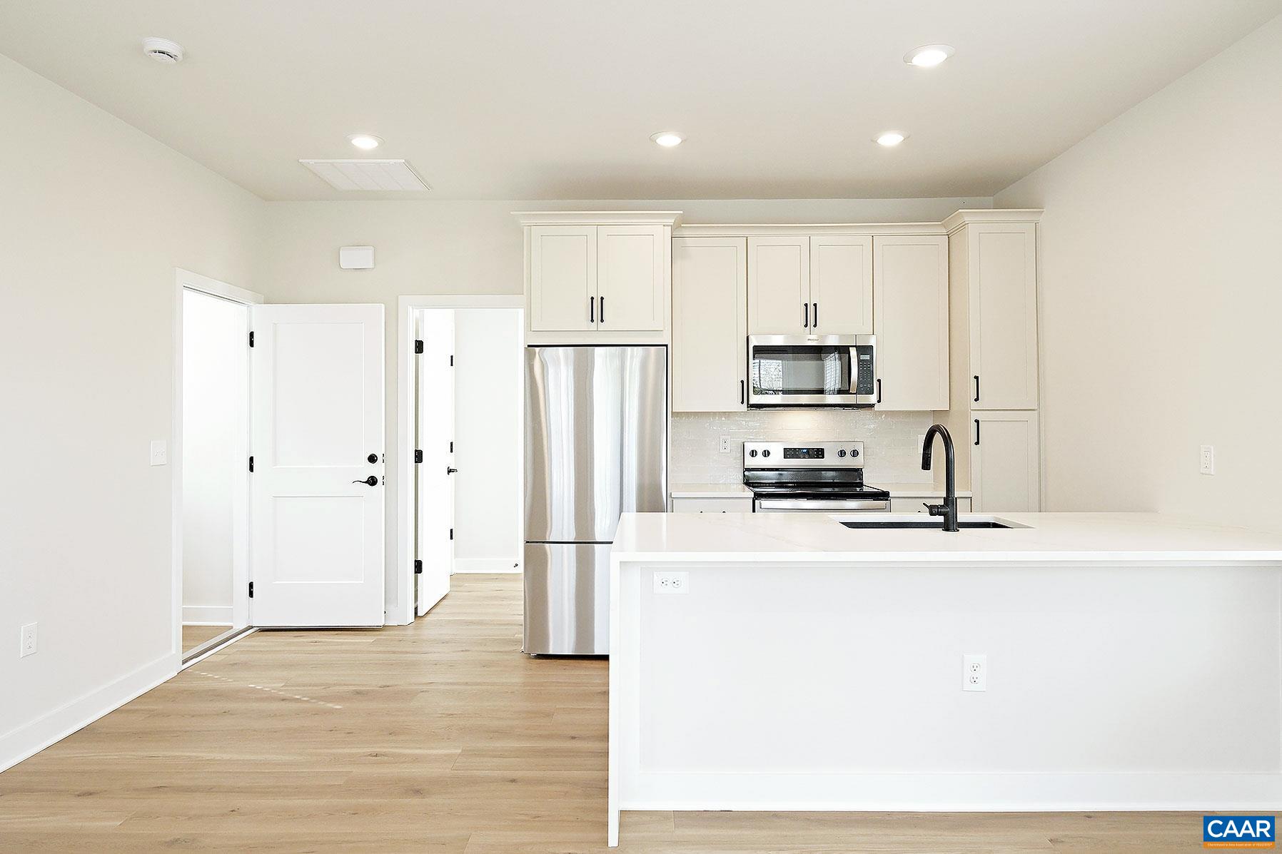 917 Belmont Avenue, Unit A Charlottesville, VA 22902 - Photo 1 of 11 a kitchen with stainless steel appliances granite countertop a refrigerator sink and white cabinets