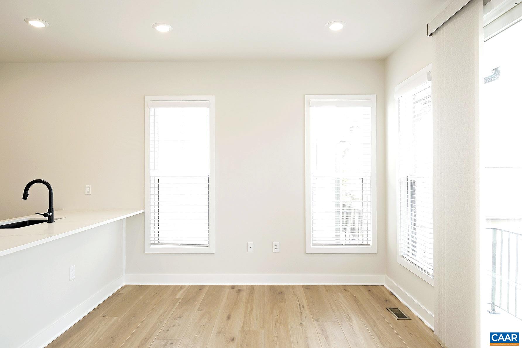 917 Belmont Avenue, Unit A Charlottesville, VA 22902 - Photo 4 of 11 a view of a room with wooden floor and windows