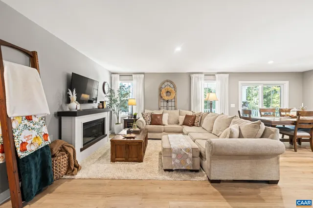 a kitchen with stainless steel appliances granite countertop a stove top oven a sink dishwasher and white cabinets with wooden floor