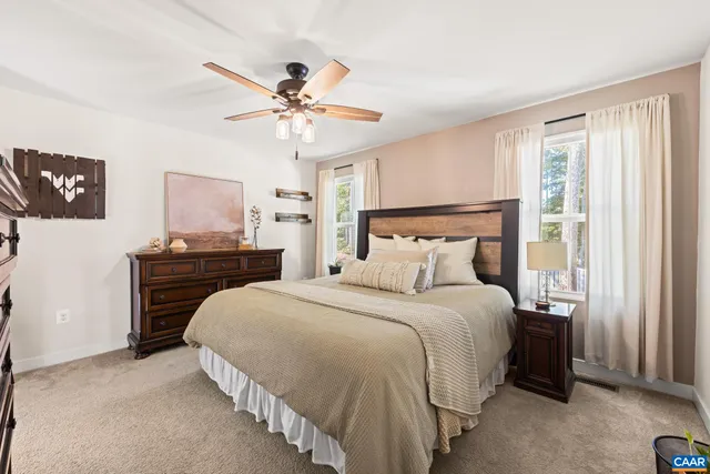 a bedroom with a bed and ceiling fan