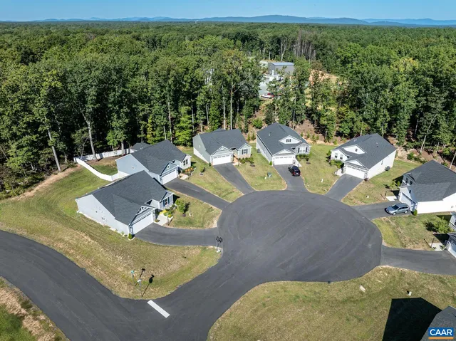 an aerial view of a house with backyard