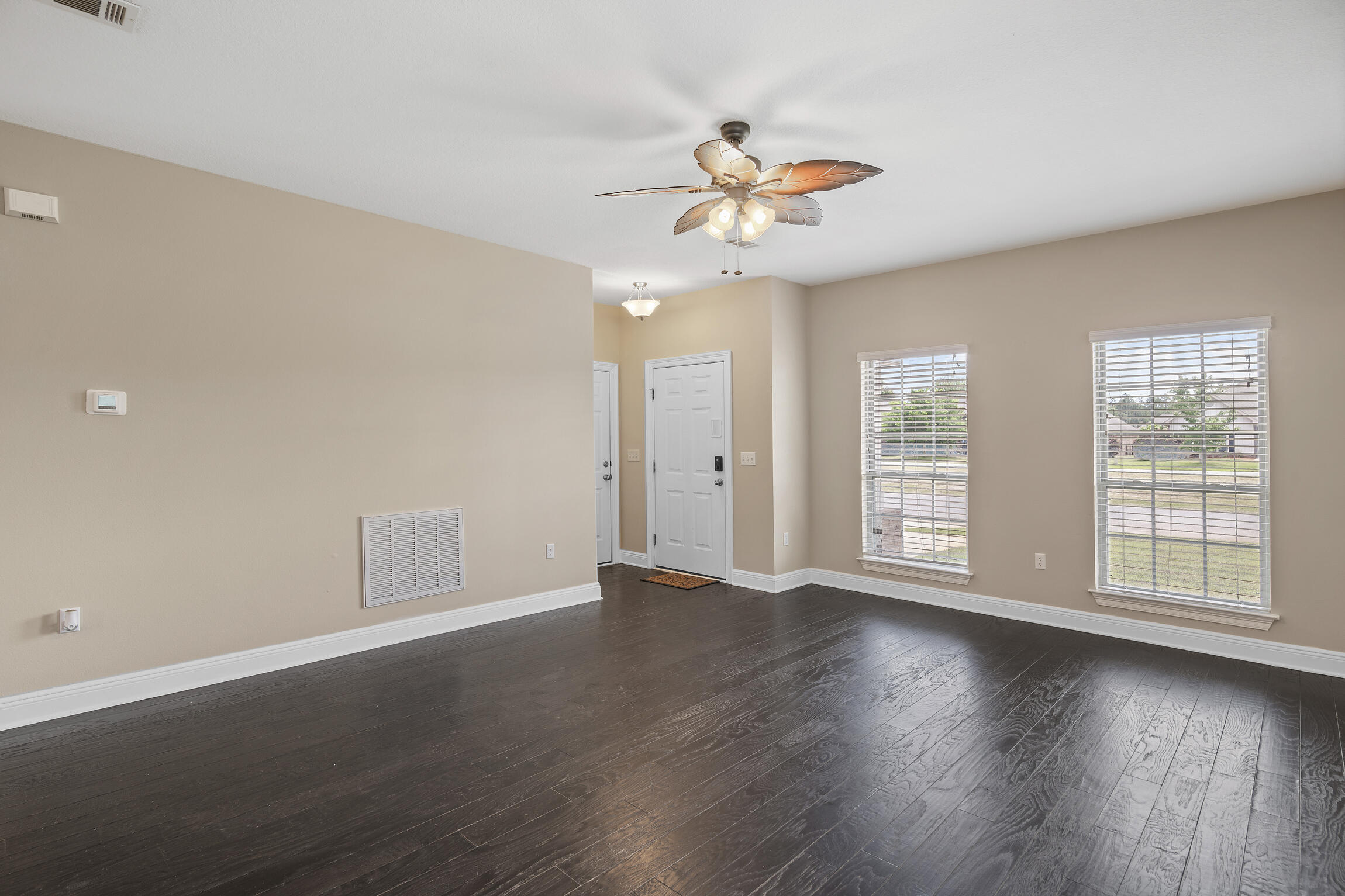 159 Lullaby Loop Santa Rosa Beach, FL 32459 - Photo 5 of 42 a view of an empty room with wooden floor and window