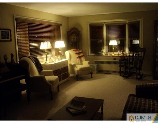120 Main Street Edison, NJ 08837 - Photo 2 of 14 a living room with furniture and a large window