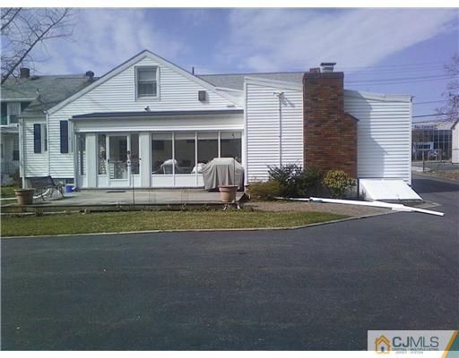 120 Main Street Edison, NJ 08837 - Photo 13 of 14 a front view of a house with a garden and porch