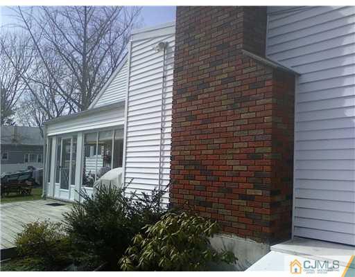120 Main Street Edison, NJ 08837 - Photo 14 of 14 a view of a house with a yard and potted plants