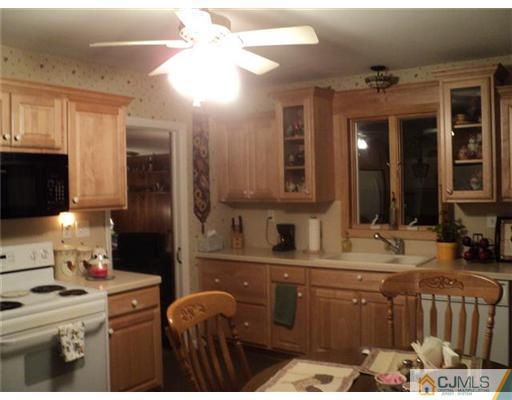 120 Main Street Edison, NJ 08837 - Photo 3 of 14 a bathroom with a double vanity sink and a mirror