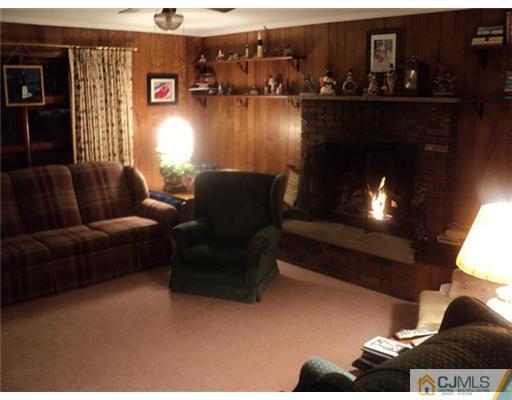 120 Main Street Edison, NJ 08837 - Photo 4 of 14 a living room with furniture and a lamp