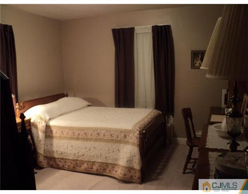 120 Main Street Edison, NJ 08837 - Photo 6 of 14 a bed sitting in a bedroom next to a window