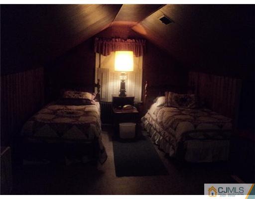 120 Main Street Edison, NJ 08837 - Photo 7 of 14 a bedroom with a bed next to a window