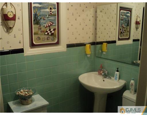 120 Main Street Edison, NJ 08837 - Photo 8 of 14 a bathroom with a sink and mirror