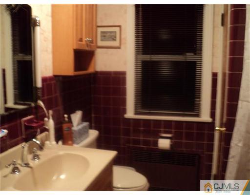 120 Main Street Edison, NJ 08837 - Photo 9 of 14 a bathroom with a sink and a mirror