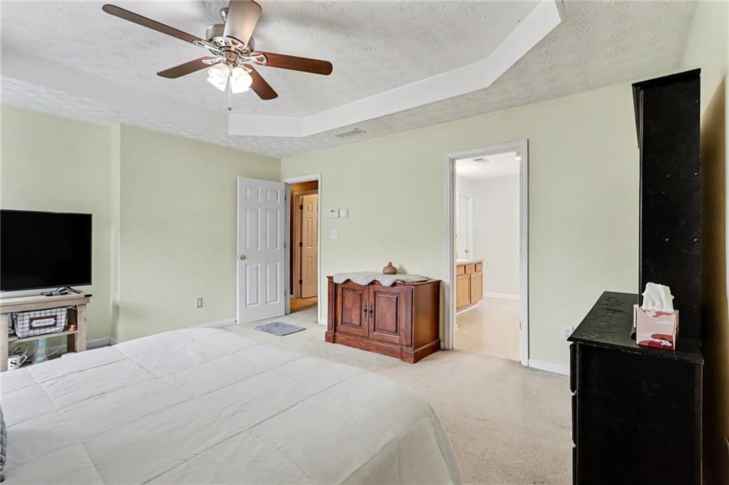 1777 Cutters Mill Way Lithonia, GA 30058 - Photo 11 of 23 a bedroom with a bed and a flat screen tv