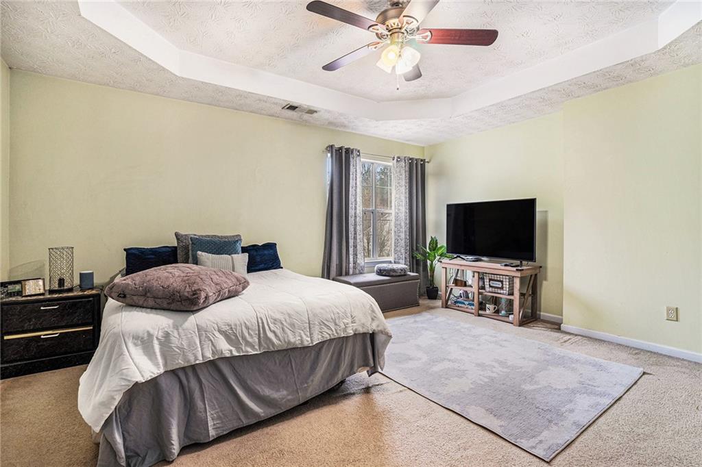 1777 Cutters Mill Way Lithonia, GA 30058 - Photo 13 of 23 a bedroom with a bed and a flat screen tv