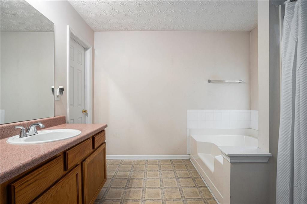 1777 Cutters Mill Way Lithonia, GA 30058 - Photo 15 of 23 a bathroom with a sink a toilet and a mirror
