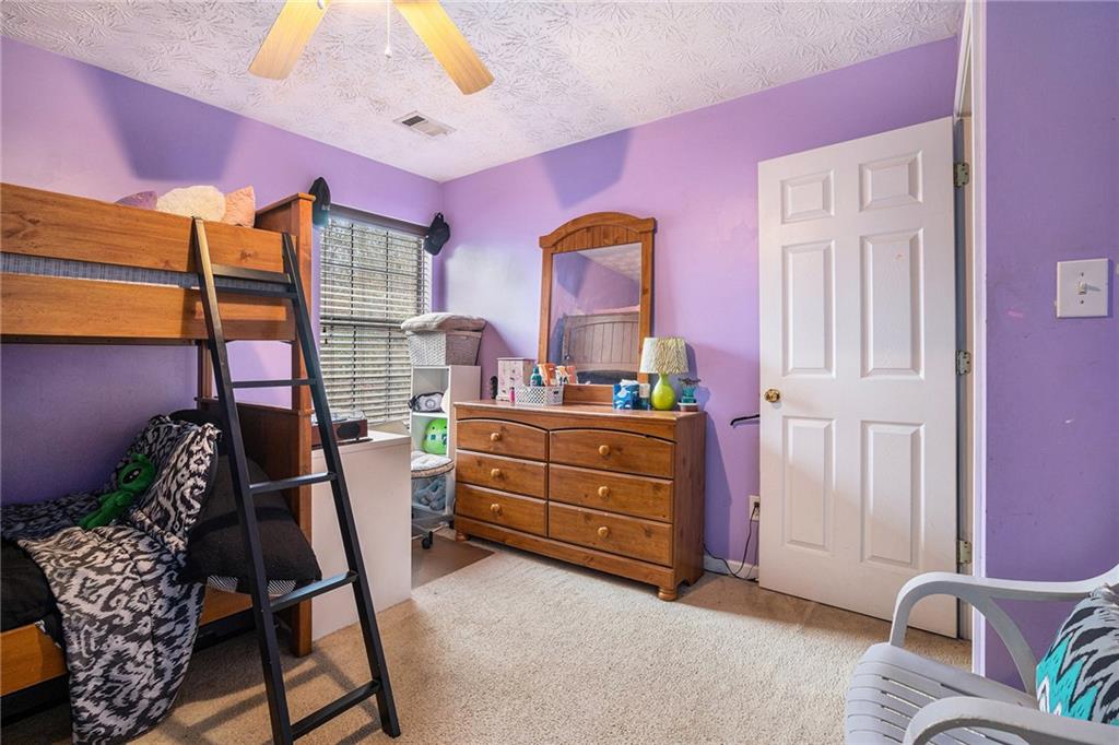 1777 Cutters Mill Way Lithonia, GA 30058 - Photo 18 of 23 a bed room with a bed and a dresser