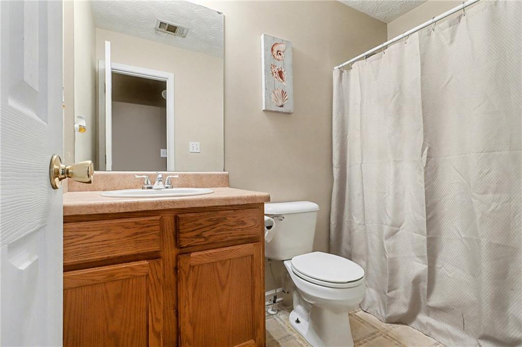 1777 Cutters Mill Way Lithonia, GA 30058 - Photo 19 of 23 a bathroom with a sink a toilet and shower
