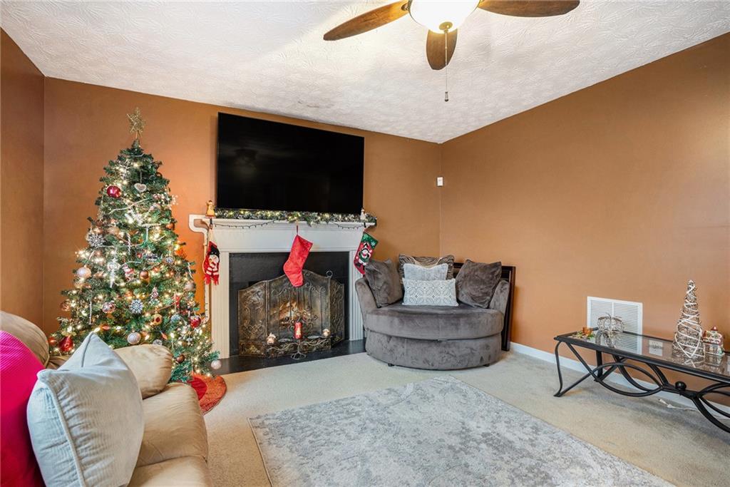 1777 Cutters Mill Way Lithonia, GA 30058 - Photo 7 of 23 a living room with furniture and a flat screen tv