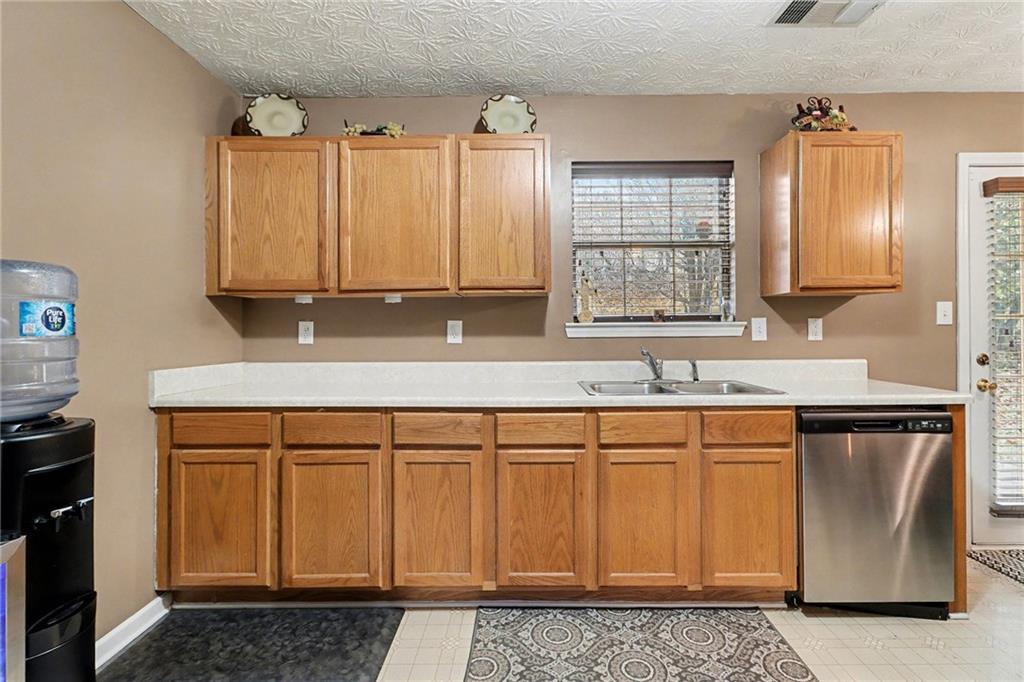 1777 Cutters Mill Way Lithonia, GA 30058 - Photo 9 of 23 a kitchen with stainless steel appliances granite countertop a sink a stove a refrigerator and cabinets