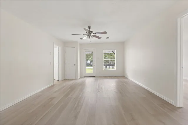 wooden floor in an empty room with a window