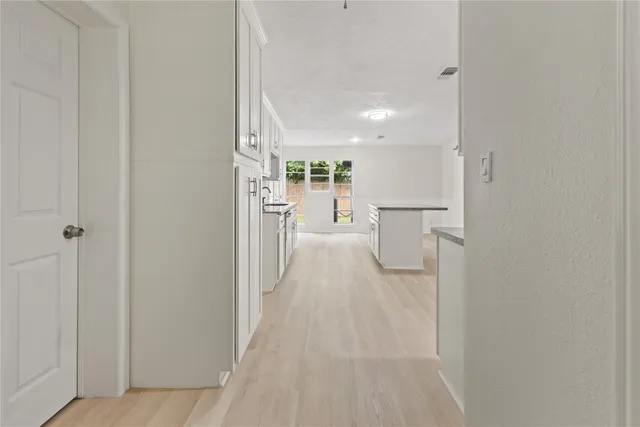 a view of a kitchen from the hallway