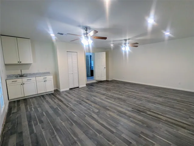 a view of a livingroom with hardwood floor and a ceiling fan