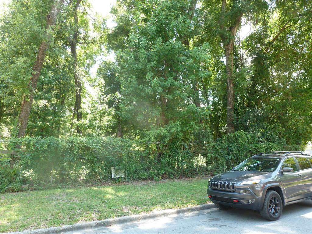 1031 Southwest 62nd Terrace Gainesville, FL 32607 - Photo 4 of 15 a view of a car parked in a yard