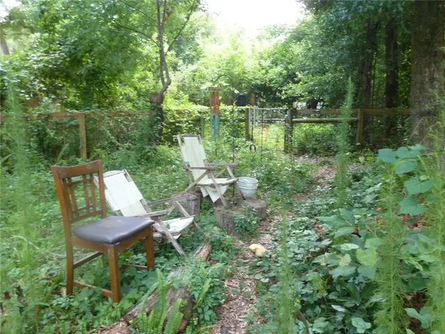 a view of a chair and table in the garden