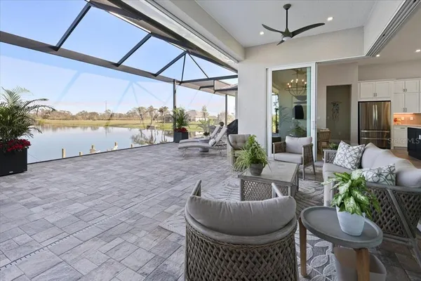 a living room with furniture and a floor to ceiling window