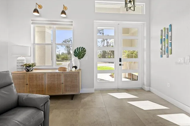 a living room with patio furniture and a flat screen tv